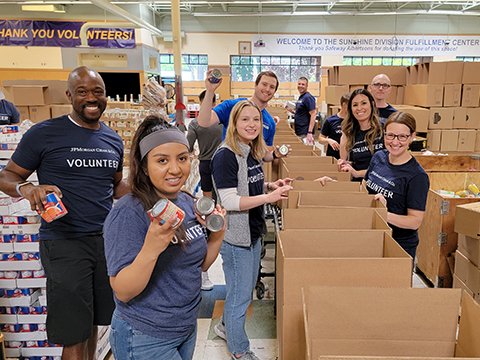 Volunteers packing food into food boxes